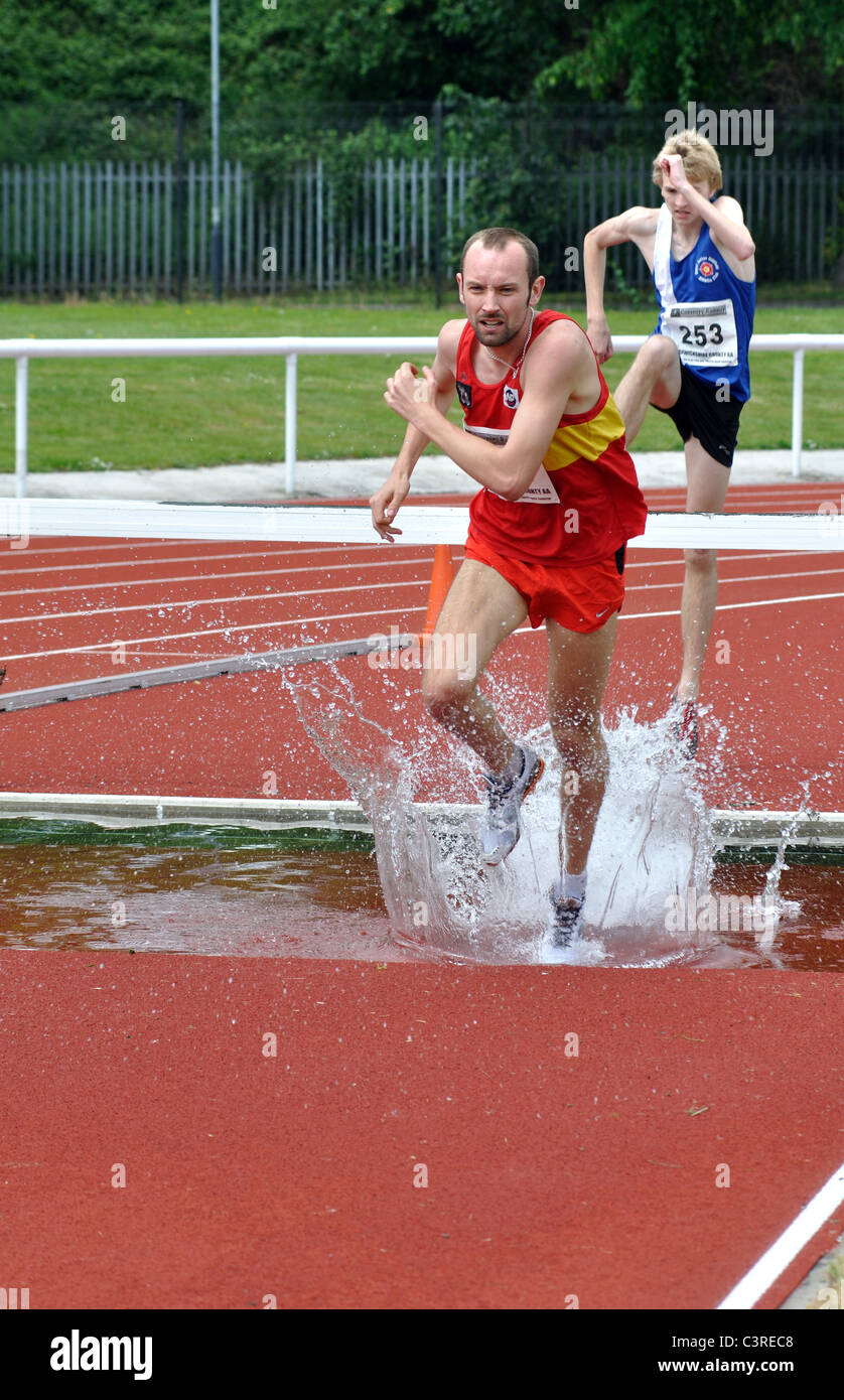 Runners in men`s steeplechase race Stock Photo Alamy